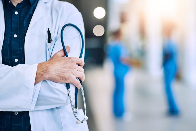 Clinicians walking through a hospital corridor