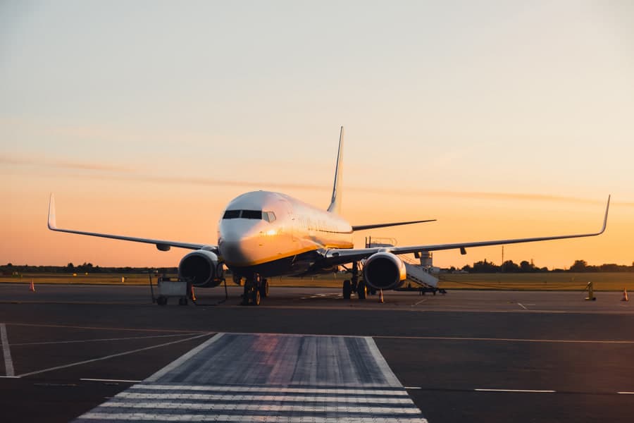 An airliner on the apron at sunset