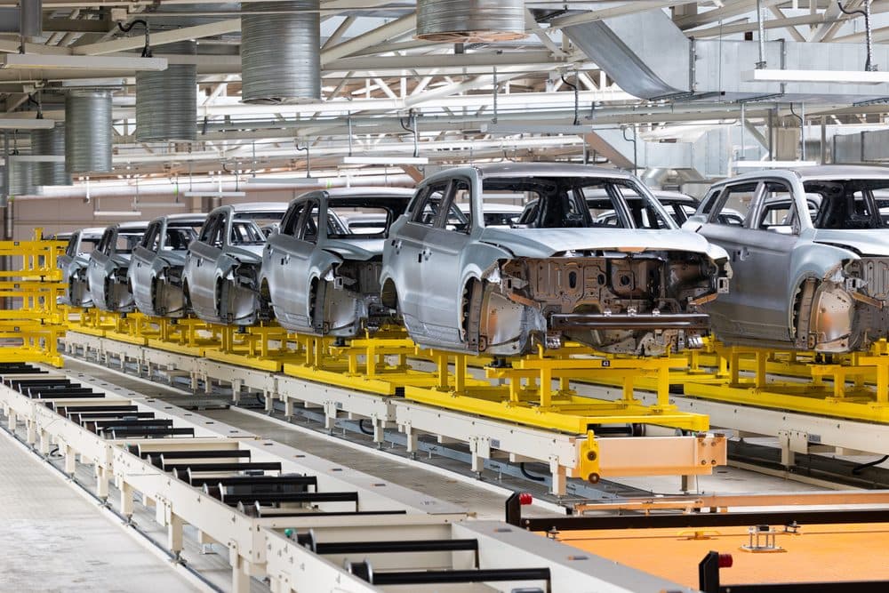 Vehicle bodies moving along an automotive assembly line